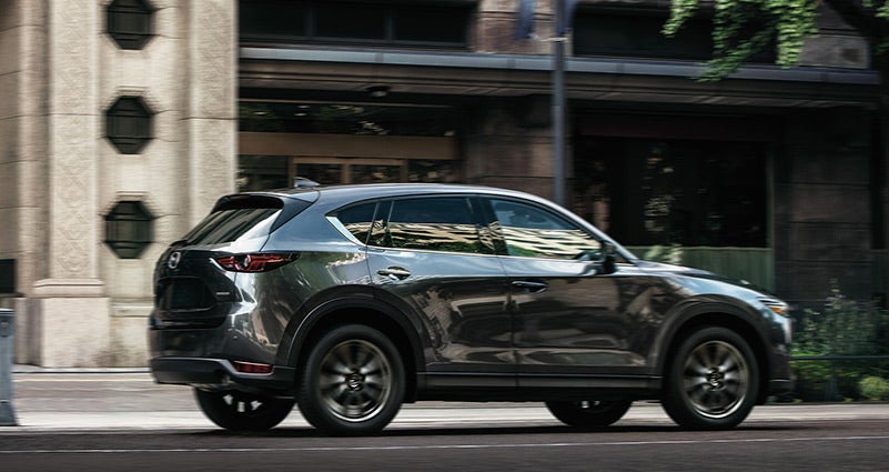 Grey 2020 Mazda CX-5 Driving on the road | Mazda of South Charlotte in Pineville, NC